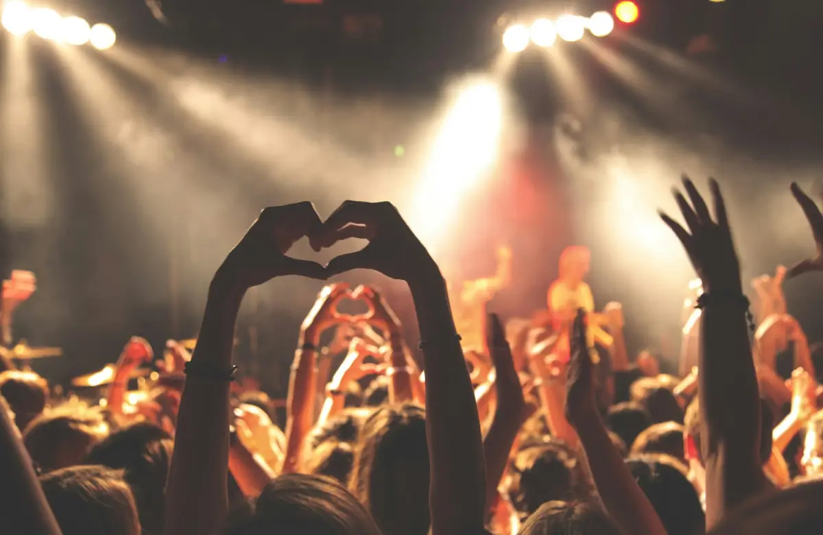 Person performing heart hand gesture photo